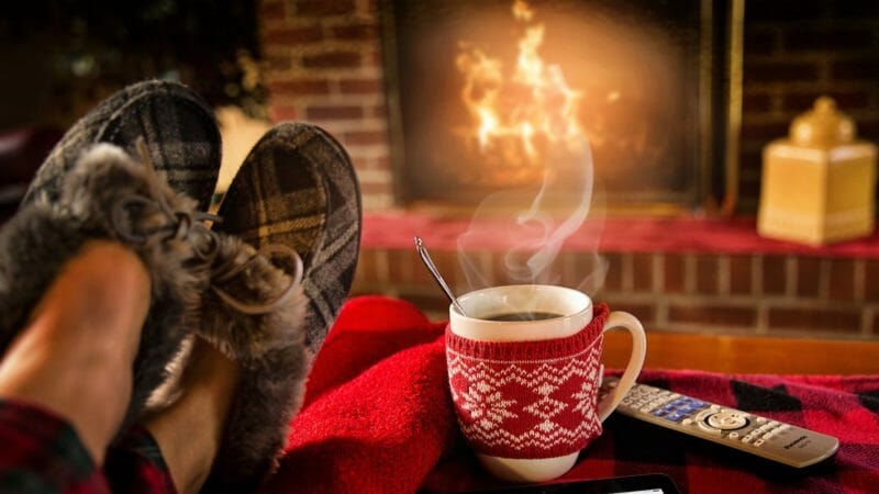 Cosy feet up in front of the fire; a wintry setting. A Step Ahead Podiatry.